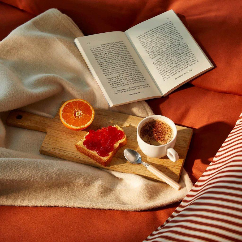 A cozy evening ritual with reading, a warm drink, and a light snack to promote relaxation before sleep